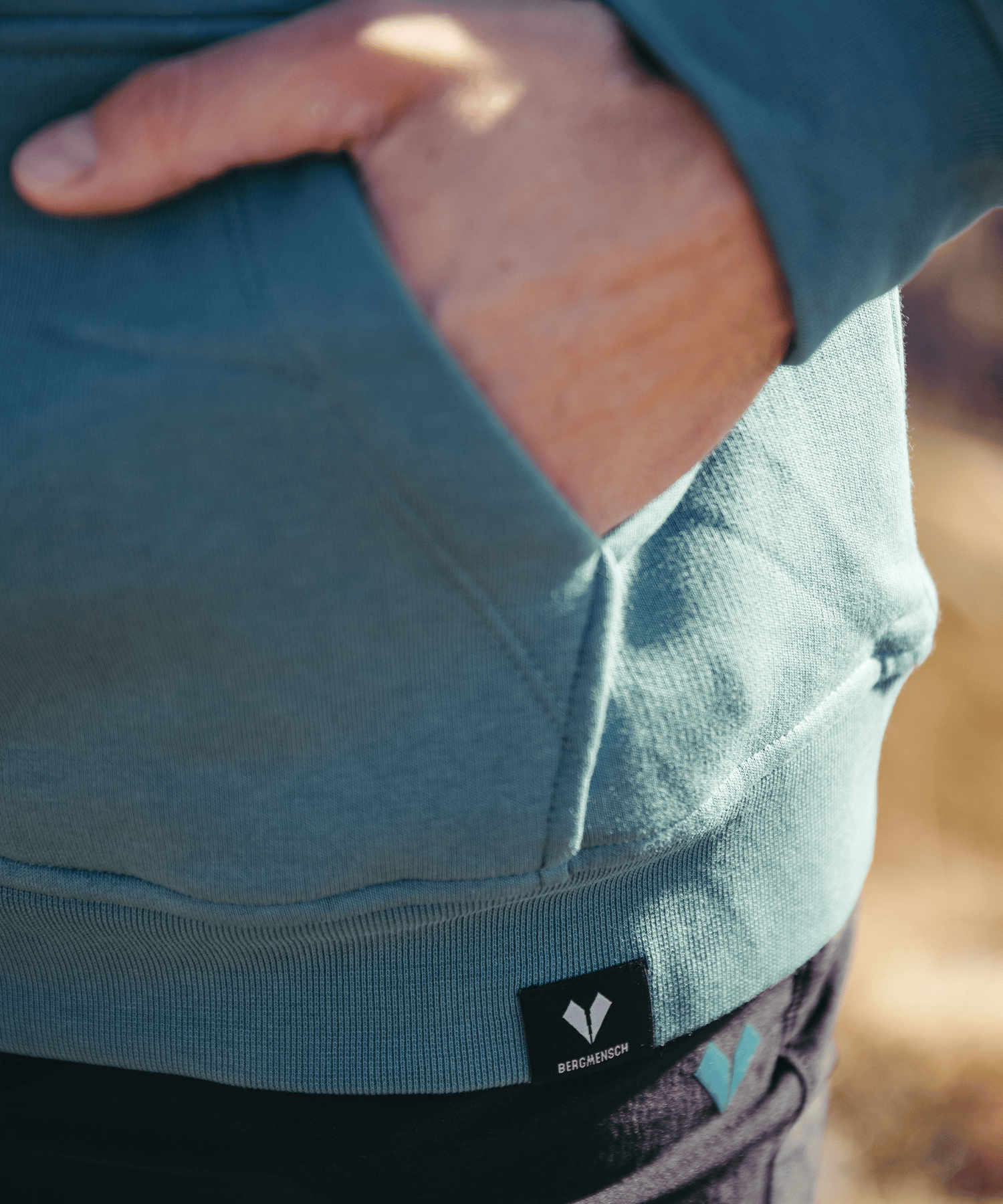 Detailbild vom BERGMENSCH Hoodie "Berg Sonne Bier Stick" in der Farbe Deep Lake